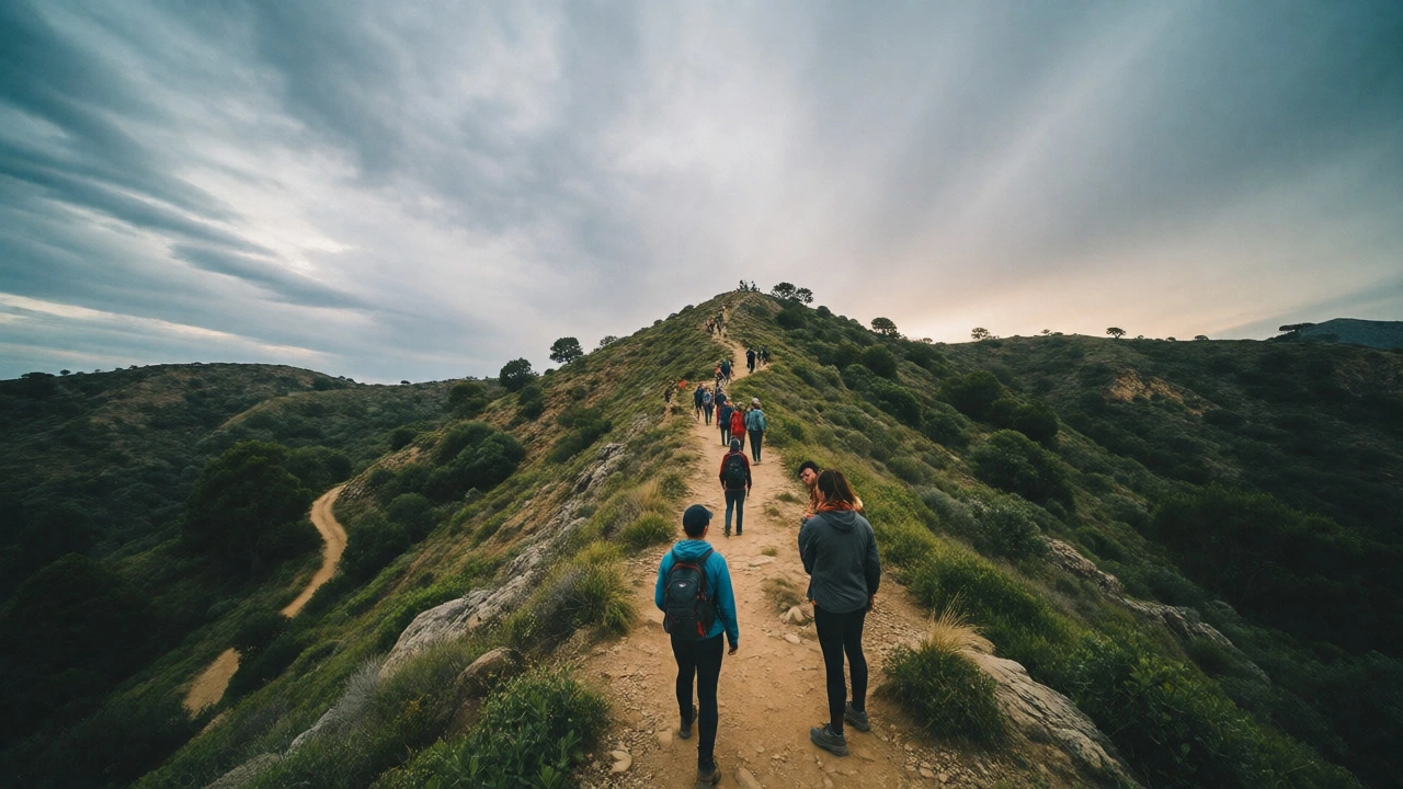 Hikers ascending a rugged trail with scenic views and variable weather.